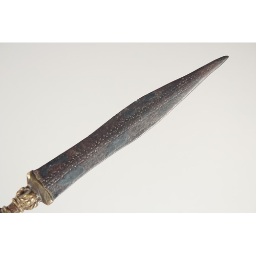 260 - AN UNUSUAL 19TH CENTURY OR EARLIER AFRICAN BRASS HILTED DAGGER, 24cm long.