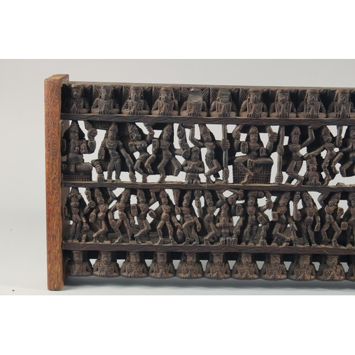 286 - A 19TH CENTURY SOUTH INDIAN CARVED WOODEN PANEL, carved with rows of deities and figures, 97.5cm x 2... 