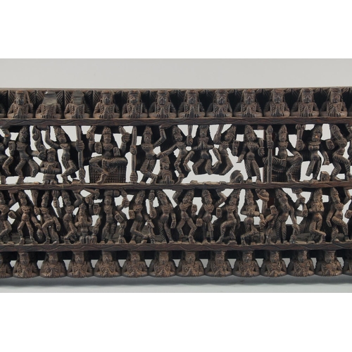 286 - A 19TH CENTURY SOUTH INDIAN CARVED WOODEN PANEL, carved with rows of deities and figures, 97.5cm x 2... 