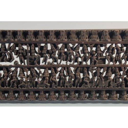 286 - A 19TH CENTURY SOUTH INDIAN CARVED WOODEN PANEL, carved with rows of deities and figures, 97.5cm x 2... 