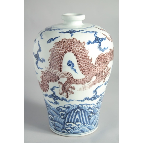 101 - A CHINESE BLUE, WHITE AND UNDERGLAZE RED PORCELAIN MEIPING VASE, painted with a dragon above waves, ... 