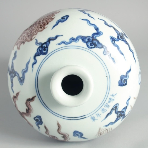 101 - A CHINESE BLUE, WHITE AND UNDERGLAZE RED PORCELAIN MEIPING VASE, painted with a dragon above waves, ... 