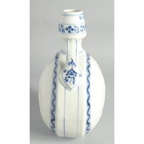 106 - A CHINESE BLUE AND WHITE PORCELAIN TWIN HANDLE MOONFLASK, the central design carved with a yin-yang ... 