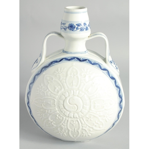 106 - A CHINESE BLUE AND WHITE PORCELAIN TWIN HANDLE MOONFLASK, the central design carved with a yin-yang ... 