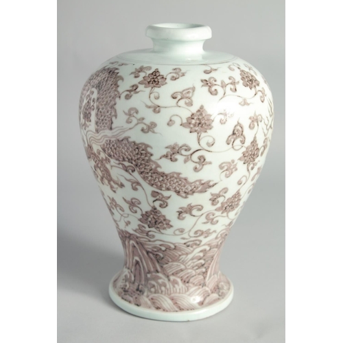 107 - A CHINESE UNDERGLAZE RED PORCELAIN MEIPING VASE, decorated with a dragon and lotus above stylised wa... 