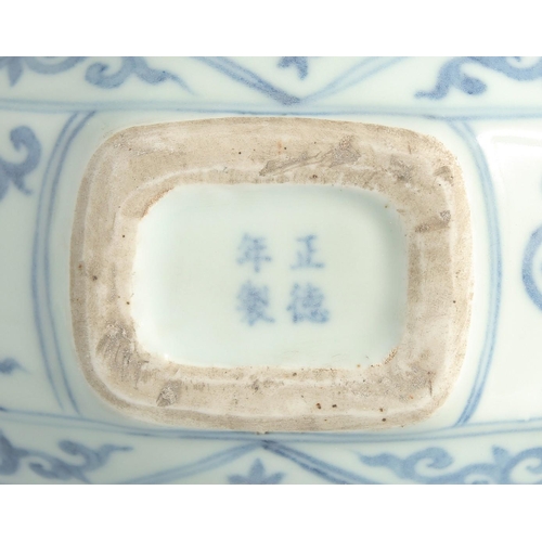 115 - A CHINESE BLUE AND WHITE PORCELAIN TWIN HANDLE MOONFLASK, with a central roundel of characters to ea... 