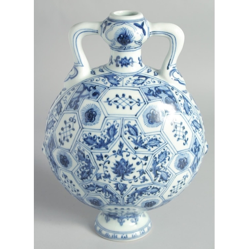 117 - A CHINESE BLUE AND WHITE PORCELAIN TWIN HANDLE MOONFLASK, decorated with floral panels, 28.5cm high.