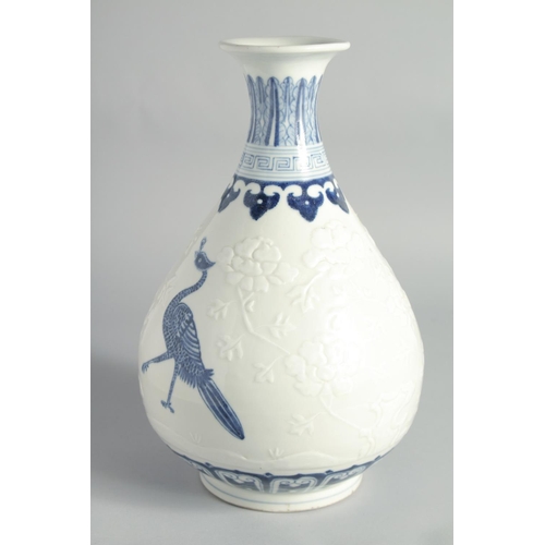 118 - A CHINESE BLUE AND WHITE PORCELAIN YUHUCHUNPIN VASE, with peacocks and carved peonies, bearing a six... 