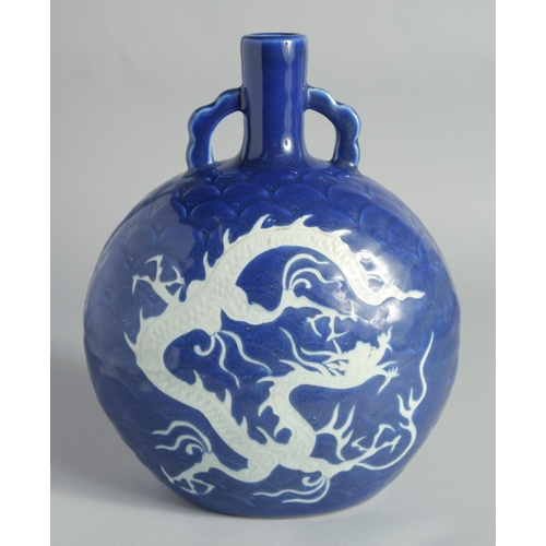 119 - A CHINESE SACRIFICIAL BLUE AND WHITE PORCELAIN TWIN HANDLE MOONFLASK, with carved dragon and scale-f... 