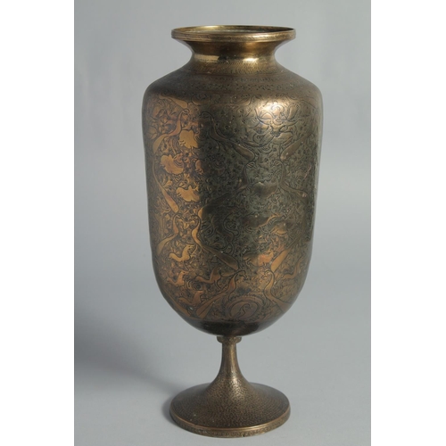 12 - A TALL ISLAMIC ENGRAVED BRASS PEDESTAL VASE, the engraved and chased decoration depicting deities an... 