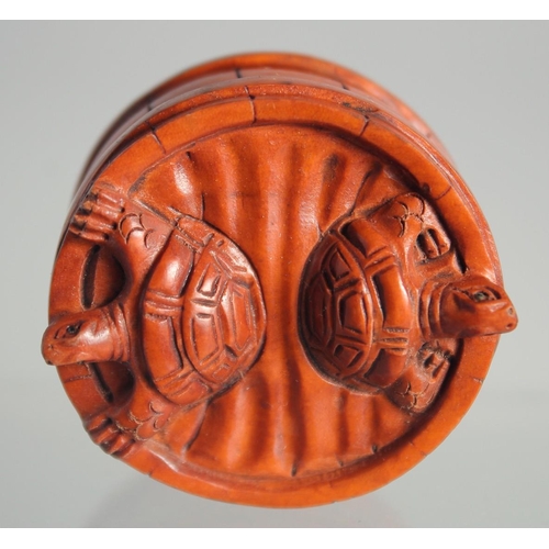 122 - A JAPANESE BOXWOOD NETSUKE OF TORTOISES in a barrel.