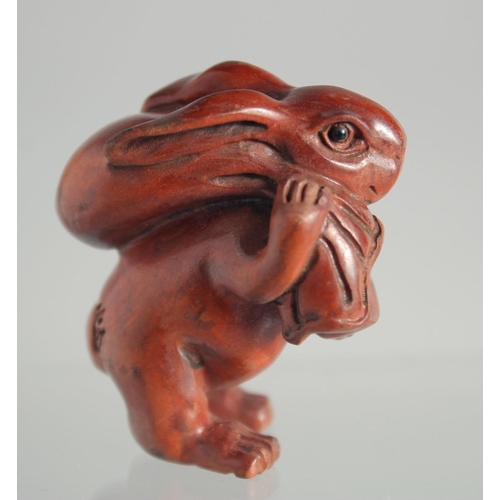 123 - A JAPANESE BOXWOOD NETSUKE OF A RABBIT.