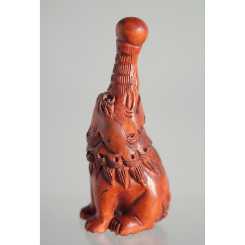 128 - A JAPANESE BOXWOOD NETSUKE OF A MYTHICAL BEAST.