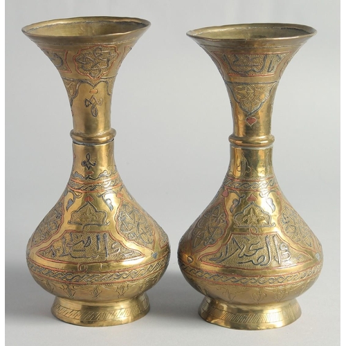 13 - A PAIR OF CAIROWARE SILVER AND COPPER OVERLAID BRASS VASES, with panels of calligraphy, 23cm high.