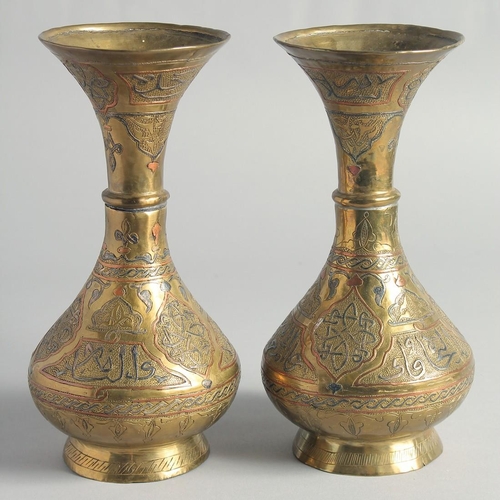 13 - A PAIR OF CAIROWARE SILVER AND COPPER OVERLAID BRASS VASES, with panels of calligraphy, 23cm high.