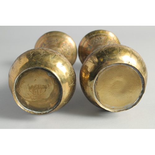 13 - A PAIR OF CAIROWARE SILVER AND COPPER OVERLAID BRASS VASES, with panels of calligraphy, 23cm high.