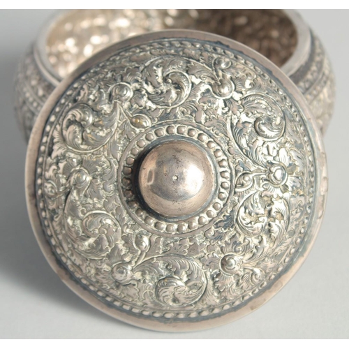 15 - AN CAMBODIAN SILVER CIRCULAR LIDDED BOX, with embossed and engraved foliate decoration, stamped to b... 