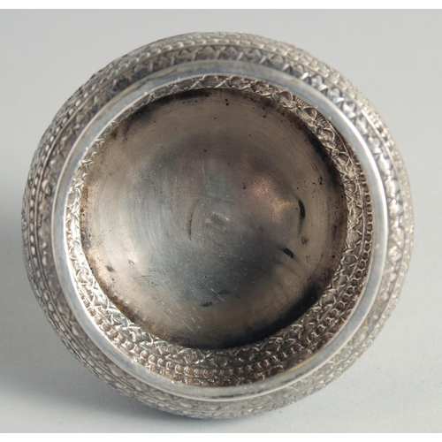 15 - AN CAMBODIAN SILVER CIRCULAR LIDDED BOX, with embossed and engraved foliate decoration, stamped to b... 