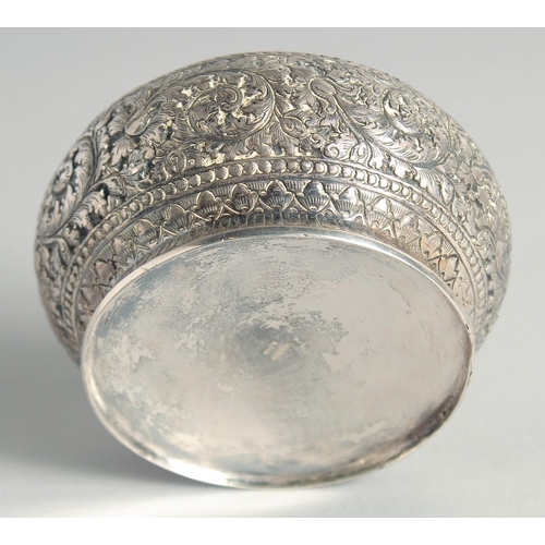 15 - AN CAMBODIAN SILVER CIRCULAR LIDDED BOX, with embossed and engraved foliate decoration, stamped to b... 