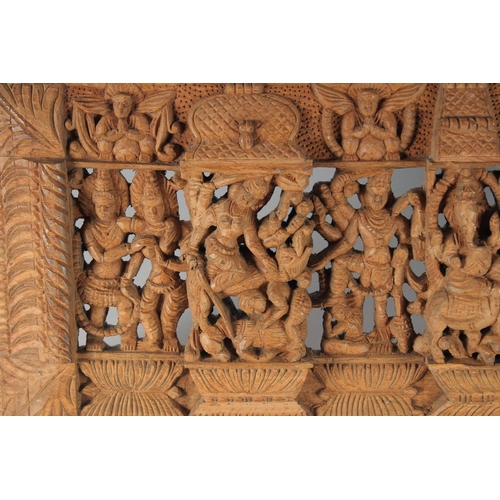 17 - A THAI CARVED AND PIERCED RECTANGULAR WOODEN PANEL, depicting deities, animals and musicians, 73cm x... 