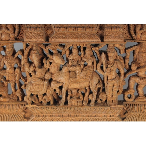 17 - A THAI CARVED AND PIERCED RECTANGULAR WOODEN PANEL, depicting deities, animals and musicians, 73cm x... 