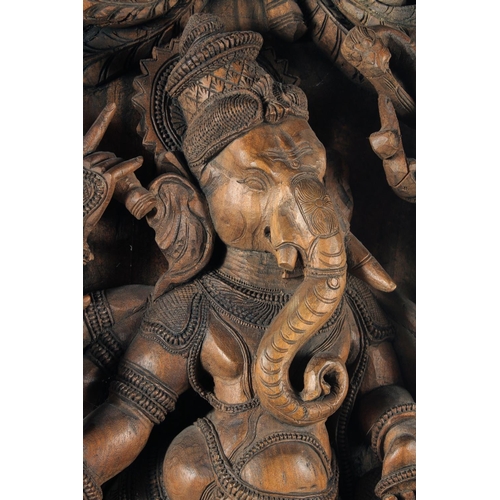 18 - A LARGE INDIAN CARVED WOOD PANEL OF GANESH, 76.5cm x 37cm.