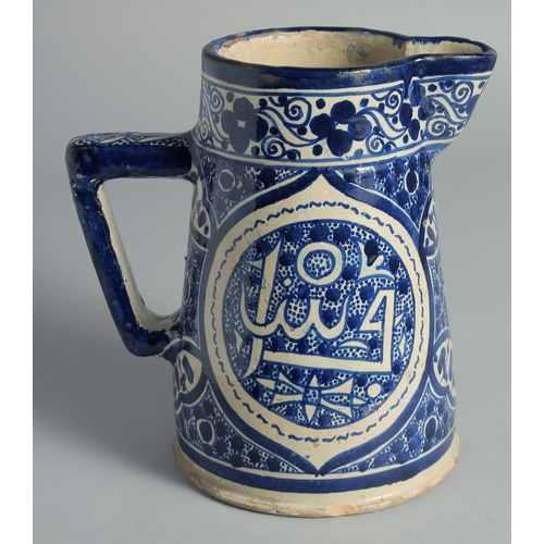 20 - AN ISLAMIC BLUE AND WHITE GLAZED POTTERY EWER, 20.5cm high.