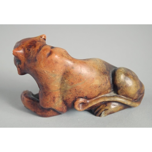 24 - A CARVED HARDSTONE FIGURE OF A TIGER, 11cm long.