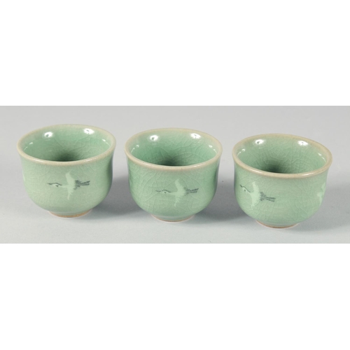 30 - A CELADON CRACKLE GLAZED JAR AND COVER, together with three Korean cups, (4).