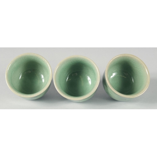 30 - A CELADON CRACKLE GLAZED JAR AND COVER, together with three Korean cups, (4).