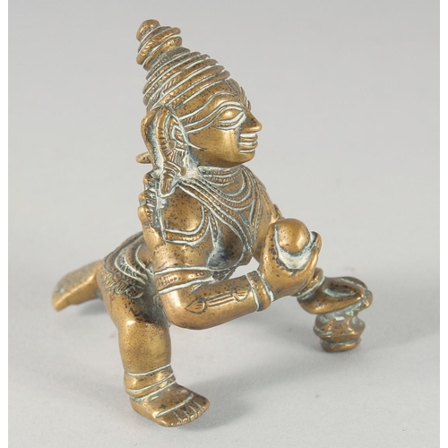 308 - A 19TH CENTURY INDIAN BRASS FIGURE OF CRAWLING KRISHNA, 8cm high.