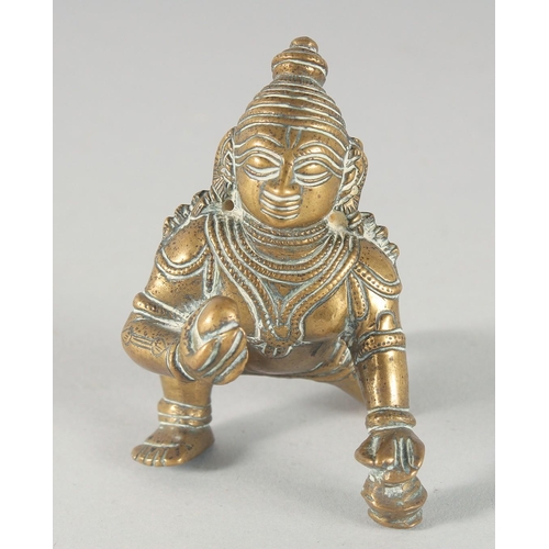 308 - A 19TH CENTURY INDIAN BRASS FIGURE OF CRAWLING KRISHNA, 8cm high.