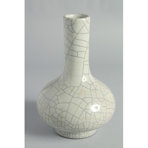 31 - A CHINESE CRACKLE GLAZE BOTTLE VASE, the base with six-character mark, 23cm high.