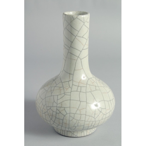 31 - A CHINESE CRACKLE GLAZE BOTTLE VASE, the base with six-character mark, 23cm high.