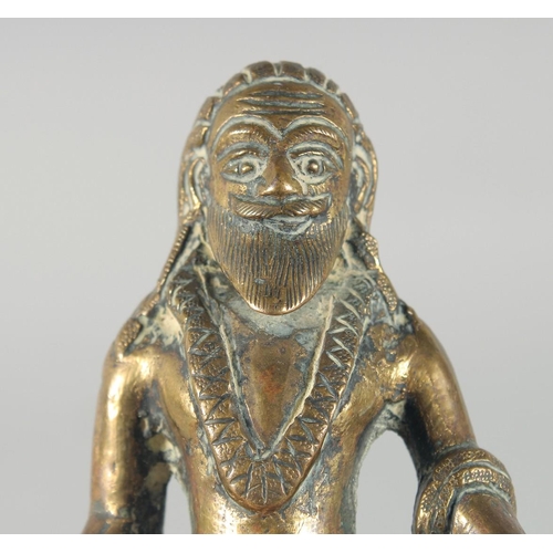 310 - A 19TH CENTURY INDIAN BRASS FIGURE OF SADHU, 13cm high.