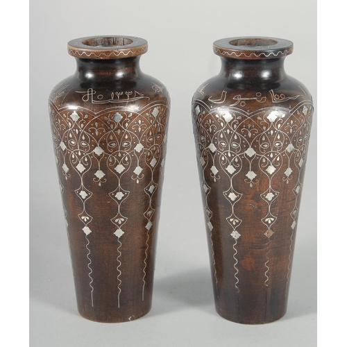 317 - A FINE PAIR OF OTTOMAN TURKISH SILVER INLAID WOODEN VASES, signed, 16.5cm high.