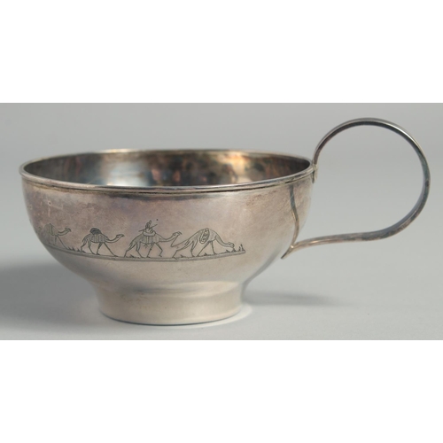 328 - A LARGE IRAQI SILVER CUP AND SAUCER, with engraved decoration of camels and boats, weight 220g, (2 p... 