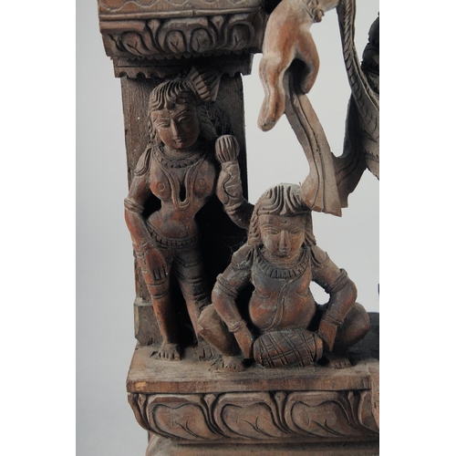 347 - A FINE 19TH-20TH CENTURY INDIAN CARVED WOODEN GROUP, depicting a central dancing figure, 49cm x 32cm... 