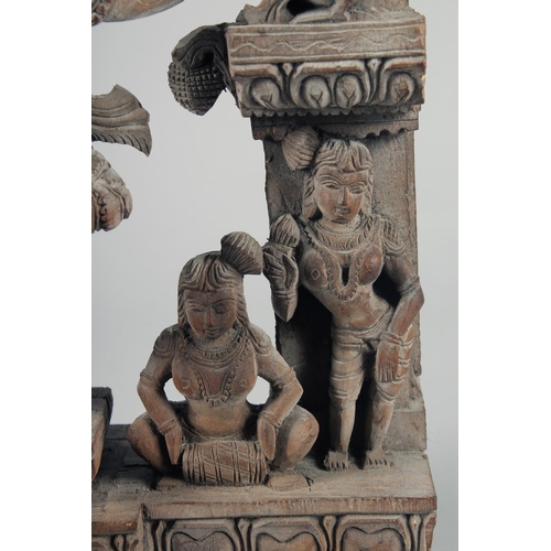 347 - A FINE 19TH-20TH CENTURY INDIAN CARVED WOODEN GROUP, depicting a central dancing figure, 49cm x 32cm... 