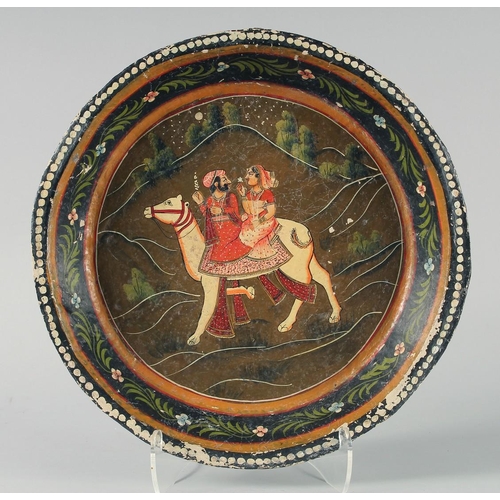 352 - A LARGE INDIAN KASHMIR LACQUERED DISH, the centre painted with a male and female riding a camel, 38c... 