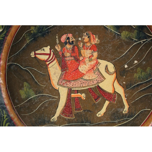 352 - A LARGE INDIAN KASHMIR LACQUERED DISH, the centre painted with a male and female riding a camel, 38c... 