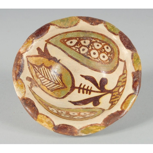 366 - A SMALL ABBASID GLAZED POTTERY BOWL, the interior painted with foliate motif, 11cm diameter.