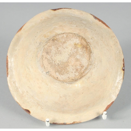 366 - A SMALL ABBASID GLAZED POTTERY BOWL, the interior painted with foliate motif, 11cm diameter.