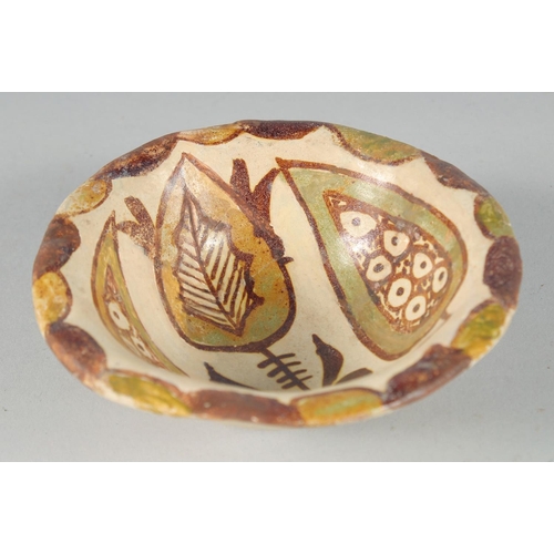 366 - A SMALL ABBASID GLAZED POTTERY BOWL, the interior painted with foliate motif, 11cm diameter.