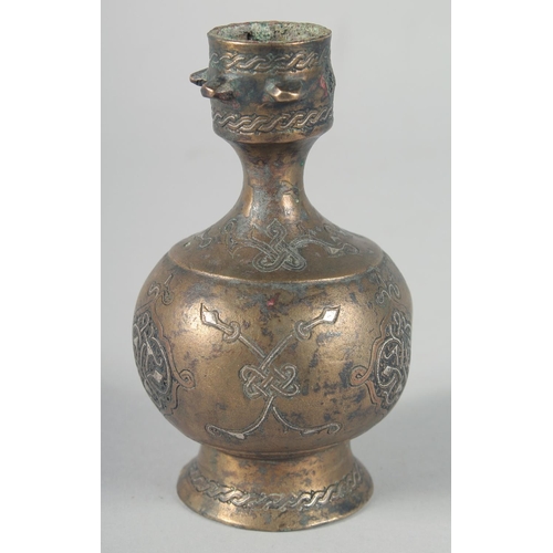 371 - AN EARLY SELJUK SILVER INLAID BOTTLE, possibly 13th century, 12cm high.