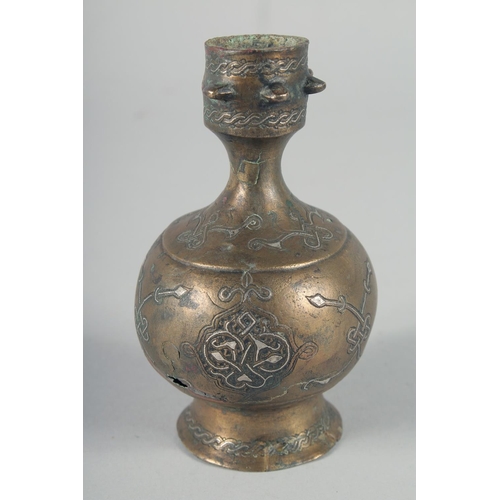 371 - AN EARLY SELJUK SILVER INLAID BOTTLE, possibly 13th century, 12cm high.