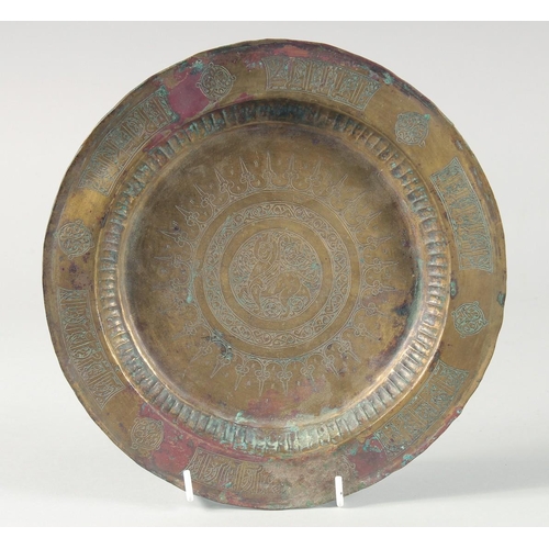 372 - A 13TH CENTURY SELJUK BRASS TRAY, with engraved decoration, 24cm diameter.