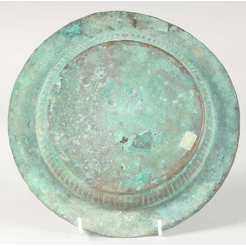 372 - A 13TH CENTURY SELJUK BRASS TRAY, with engraved decoration, 24cm diameter.