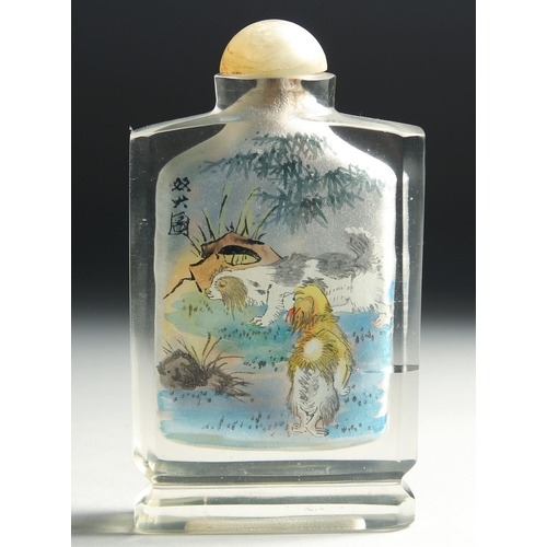 4 - A CHINESE REVERSE PAINTED GLASS SNUFF BOTTLE with hardstone stopper, decorated with a monkey to one ... 