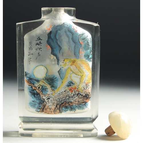 4 - A CHINESE REVERSE PAINTED GLASS SNUFF BOTTLE with hardstone stopper, decorated with a monkey to one ... 